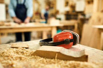 Wall Mural - Close up of carpenters workstation with wood shavings on table, copy space