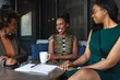 © Gerald Carter/Creative Flame - Smiling businesswomen sit in meeting