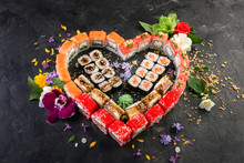 Set Of Heart Shaped Roll Decorated With Flowers, Black Stone Background