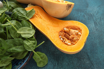 pumpkin butternut and fresh spinach on the table