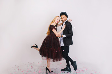 Happy great celebration of Valentine s day of excited couple in love having fun on white background. Luxury evening clothes, expressing positivity, smiling, dancing, laughing