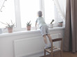 © kulikovan - The little boy is standing on the children's chair and looking out the window
