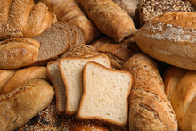 Different Kinds Of Fresh Bread As Background, Closeup