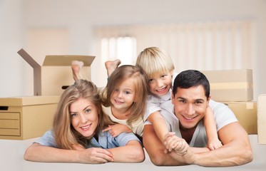 Beautiful smiling family sitting at sofa at home