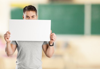 Canvas Print - Young male teacher   standing with book