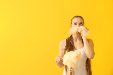 Wall Mural - Beautiful woman with cotton candy on color background