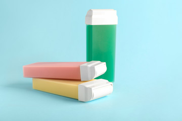 Liposoluble wax cartridges on color background