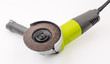 Angle grinder with abrasive disk on white background