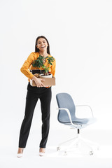 Sticker - Full length portrait of happy young woman dressed in elegant wear holding box with office supplies due to hiring