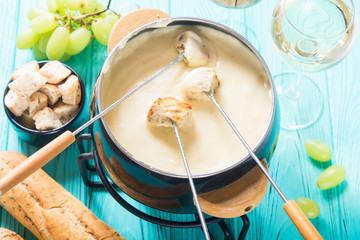 Cheese fondue with bread wine and grape