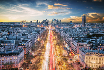 Wall Mural - Beautiful sunset over La Defense Financial District Paris France. Traffic on Champs-Elysees with red and white light trails. Modern vs. Old architecture