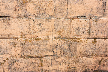 Brick wall fragment. Old dirty orange and red bricks with defects. Grunge texture with cracks and weathered