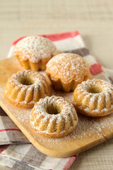 Wall Mural - Summer mini bundt cakes with simple flavors on a rustic table