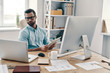 © gstockstudio - Business routine. Young modern businessman working using digital tablet while sitting in the office