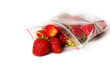 fresh strawberry in transparent open plastic bag with lock isolated on white.