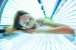 © didesign - Attractive woman in sunbed lying on her stomach