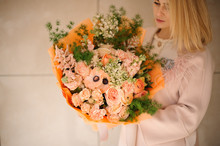 Girl Holds Bouquet With Various Orange Flowers