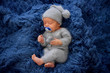 © Oksana - Sleeping newborn boy in the first days of life on blue background