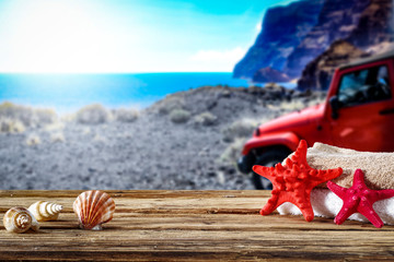 Desk of free space and summer car on beach 