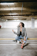 © Alexander - Young brunette woman posing on the underground parking lot. Woman in the parking lot.