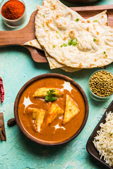 Wall Mural - Paneer Butter Masala is a popular North Indian recipe for lunch/dinner made using cottage cheese in red tomato curry. usually served with Rice and chapati/naan. selective focus