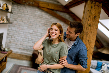 Canvas Print - Young couple embracing each other at home