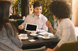 © Prostock-studio - Three people in restaurant discussing project with digital tablet