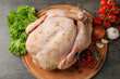 © New Africa - Wooden board with raw spiced turkey and ingredients on grey background, top view