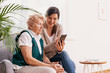 © Photographee.eu - Senior woman in nursing home with her granddaughter showing her how to use a mobile phone