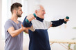 © Photographee.eu - Senior man after stroke at nursing home exercising with professional physiotherapist