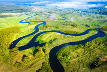 River Nature. Wild River Along Green Meadow From Above. River Landscape Aerial View. Scenic Summer Nature