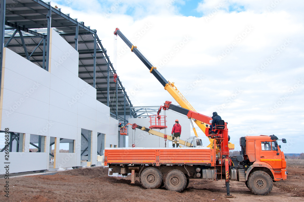Installation of insulation panels on the construction of a new building ...