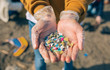 © David Pereiras - Detail of hands showing microplastics on the beach