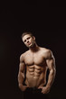 © KDdesignphoto - Muscular model young man on dark background. Fashion portrait of strong brutal guy with trendy hairstyle. Sexy naked torso, six pack abs. Male flexing his muscles. Sport workout bodybuilding concept.