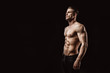 © KDdesignphoto - Muscular model young man on dark background. Fashion portrait of strong brutal guy with trendy hairstyle. Sexy naked torso, six pack abs. Male flexing his muscles. Sport workout bodybuilding concept.