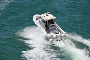 Wall Mural - Young couple enjoying a high speed pleasure cruise on the Florida Intra-Coastal Waterway in a small Sport Fishing Boat