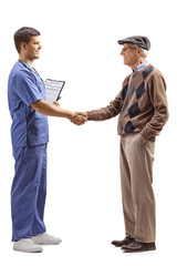 Poster - Male doctor in a blue uniform shaking hands with a senior man