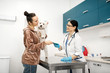 © Viacheslav Yakobchuk - Client holding dog taking the medical record of dog from vet