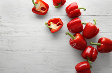 Ripe Red Peppers On White Wooden Background