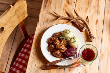 serving of wild venison goulash with deer antlers