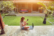 © astrosystem - Freelancer girl with smartphone, coffee / tea and laptop on a home porch.