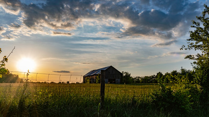 Scenic rural countryside with old barn in a field