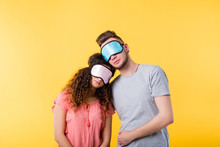 Bedtime Concept. Insomnia And Sleep Habits. Tired Young Couple In Eye Masks Falling Asleep During The Day.