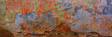 Wall Covered With Old Crumbling Cement Multi-colored Plaster.
