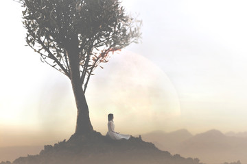 woman relaxes doing yoga under a tree