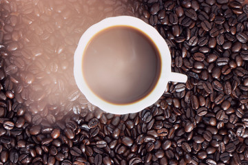 cup of coffee and beans on wooden background