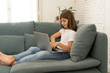 © SB Arts Media - Beautiful cute charming young girl playing and surfing the internet on laptop at home