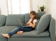 © SB Arts Media - Beautiful cute charming little girl playing and surfing the internet on laptop smiling at home