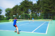 © IrynaV - Teenager boy playing tennis on court. Sport summer concept. Blurred background.