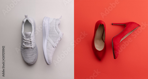 Photographie A studio shot of pair of running vs high heel shoes on color background